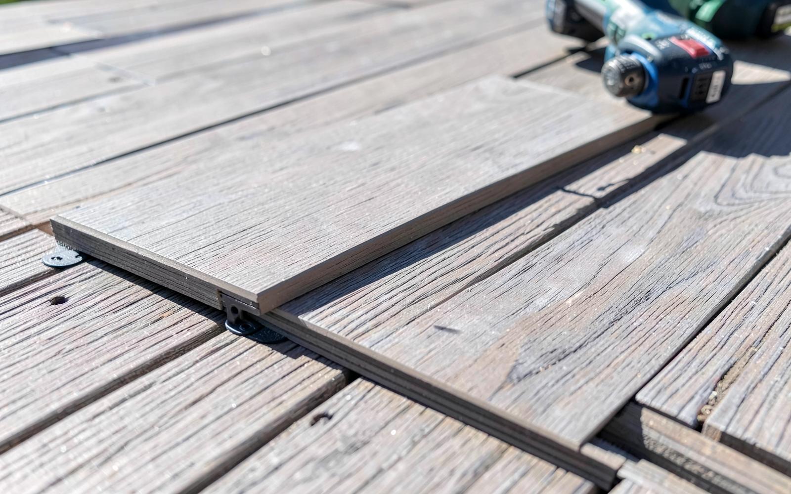 Capped composite decking boards installed with hidden fasteners during a composite deck installation in Colorado Springs.